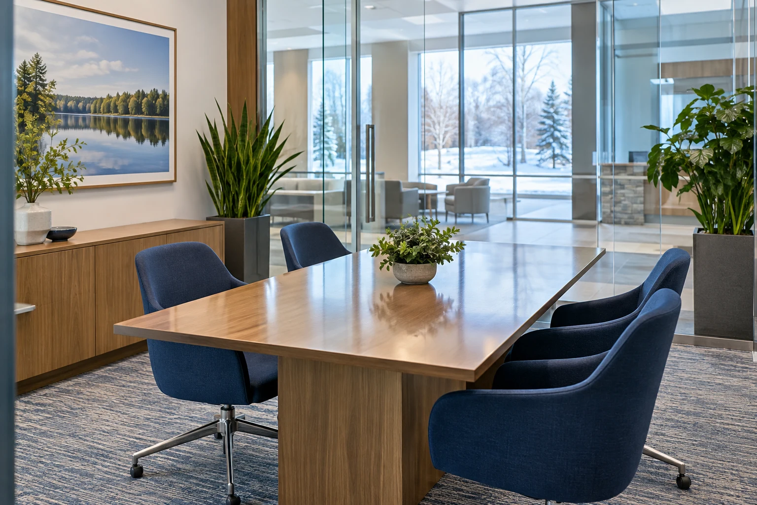 A clean bank meeting room with navy chairs and a polished table